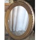 Miroir ancien en bois et platre doré, ovale, bords abimés